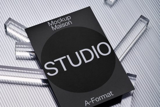 Professional black book cover mockup on striped surface with reflective acrylic blocks for showcasing design portfolio, perfect for designers and creatives.