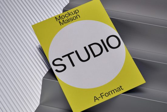 Modern brochure mockup in yellow and gray with bold typography, presented on striped surface for graphic design portfolio display.