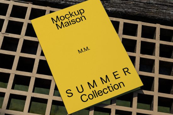 Yellow book cover mockup on a geometric metal grid with bold typography showcasing design for Summer Collection, ideal for presentations.
