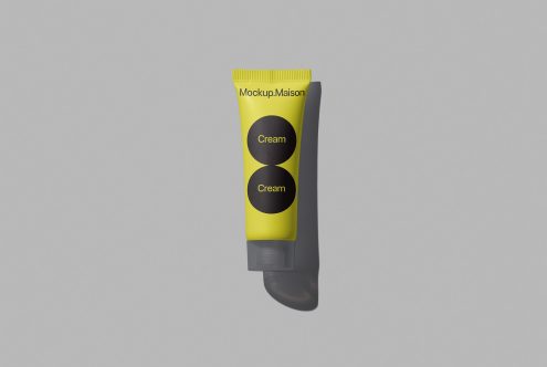 Yellow and black cosmetic tube mockup on a gray background, product packaging design, beauty and skincare presentation.