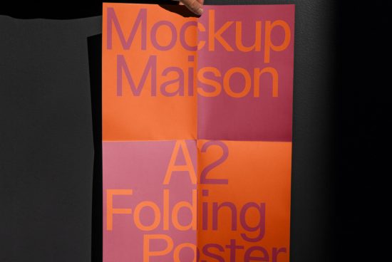 Person holding A2 size folding poster mockup with orange and purple design for graphic presentation and portfolio display.