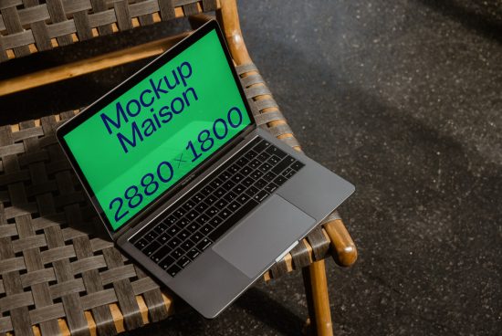 Laptop mockup on wicker chair with green screen design, high-quality digital asset for designers, creative workspace scene.