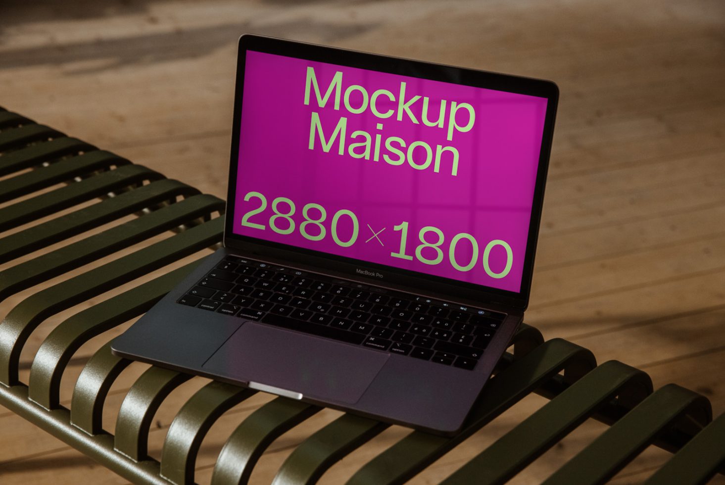 Laptop on bench with vibrant screen mockup displaying text Mockup Maison 2880x1800, ideal for designers looking for realistic mockup graphics.