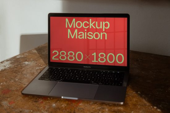 Laptop on table with screen display mockup, MacBook Pro, red overlay with dimensions, realistic shadow, ideal for digital design presentation.