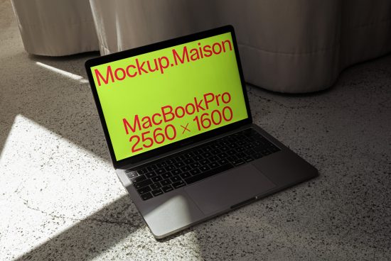 Laptop mockup on floor with sunlight casting shadows, showcasing a screen design layout, ideal for designers' presentations and digital assets.