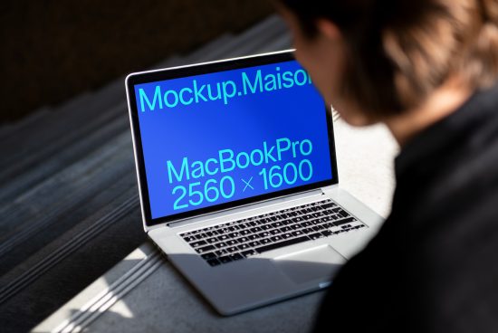 Person viewing MacBook Pro laptop screen displaying mockup information, ideal for designers in search of high-resolution device mockups.