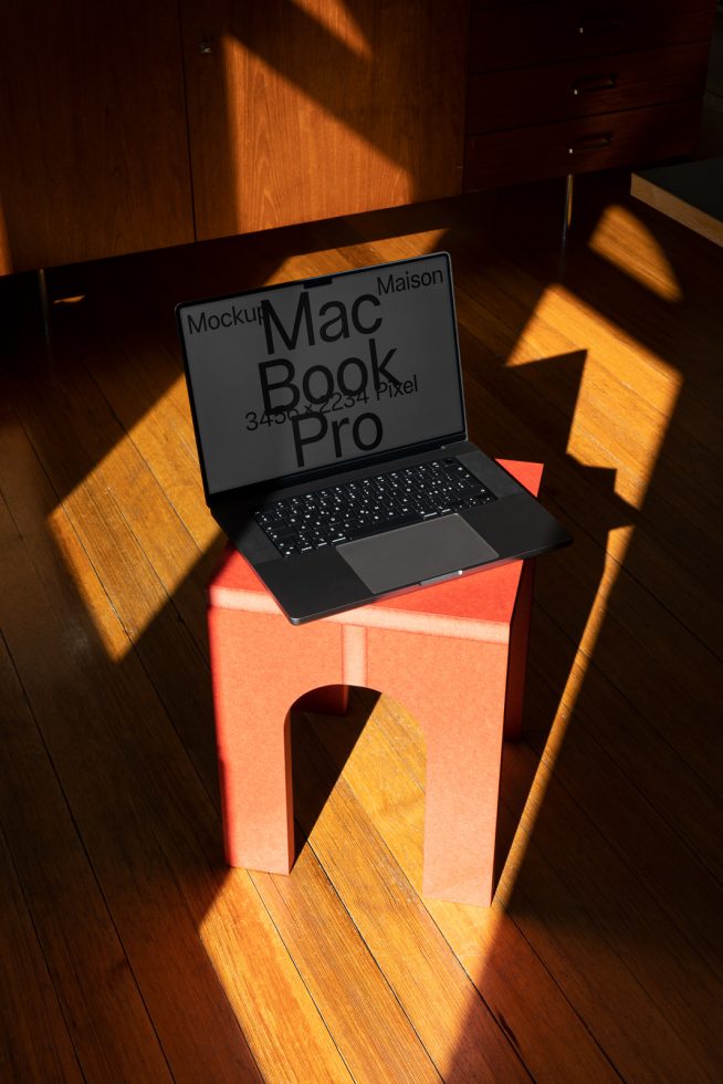 Laptop mockup on minimalist stand with natural shadows on wooden floor, ideal for showcasing web and app designs.