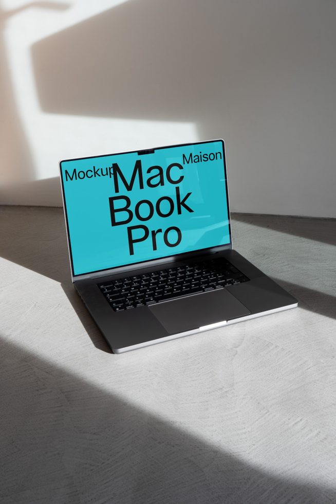 Laptop mockup on a desk with light and shadow, featuring a MacBook Pro with a customizable screen for design presentations.