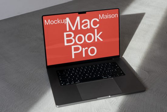 Laptop mockup on a textured surface with striking screen graphics, ideal for showcasing designs and layouts to clients.