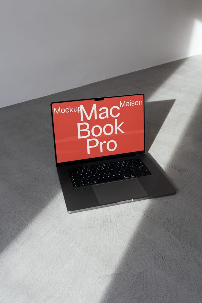 MacBook Pro mockup on floor with dramatic shadows, ideal for showcasing web design and digital assets to enhance designer portfolios.