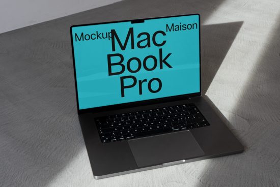 Laptop mockup featuring MacBook Pro on a textured surface with shadows, ideal for presenting digital designs and templates.