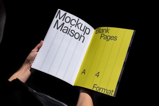 Open magazine mockup with white and yellow pages held in hand against black background, ideal for presentations and design showcases.