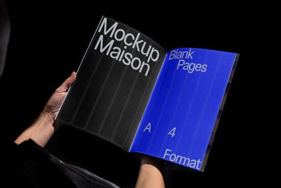Person holding open magazine mockup showing black cover design and blue interior with A4 format, ideal for presentations and portfolios.