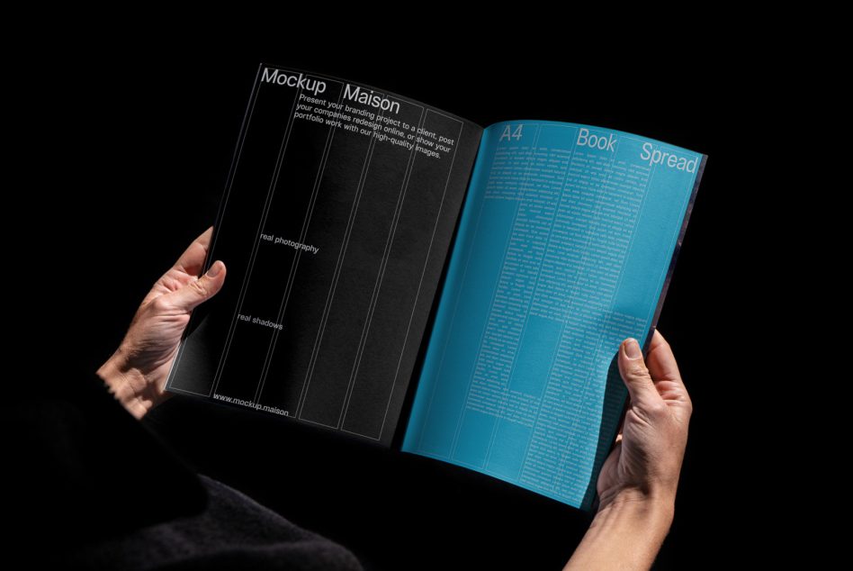 Hands holding open book mockup on black background showing left page with template text and design layout.