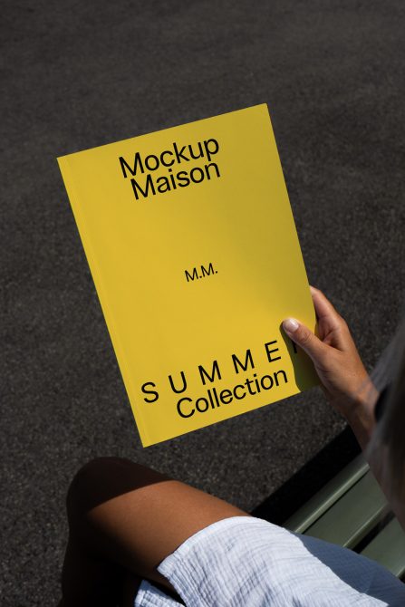 Bright yellow hardcover book held in hand against dark textured background