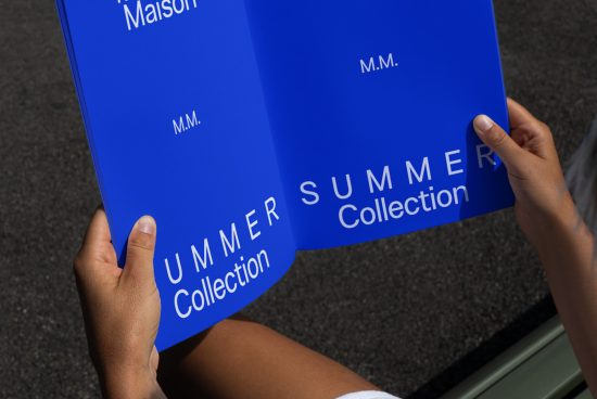 Hands holding a blue fashion flyer mockup for Summer Collection with clear typography, suitable for designers' presentation templates.
