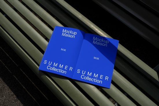 Blue book cover mockup design on park bench capturing natural shadows, ideal for presentations, summer collection theme, realistic graphic display.