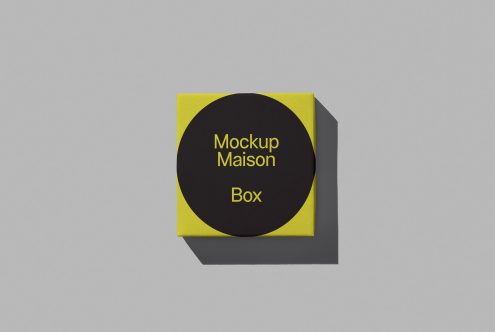 Modern yellow and black square box mockup with sleek design on a plain gray background, ideal for packaging presentations and portfolio showcases.