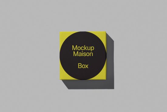 Modern yellow and black square box mockup with sleek design on a plain gray background, ideal for packaging presentations and portfolio showcases.