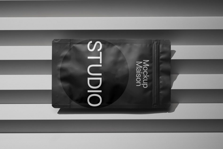 Black foil pouch mockup with circular window on striped surface
