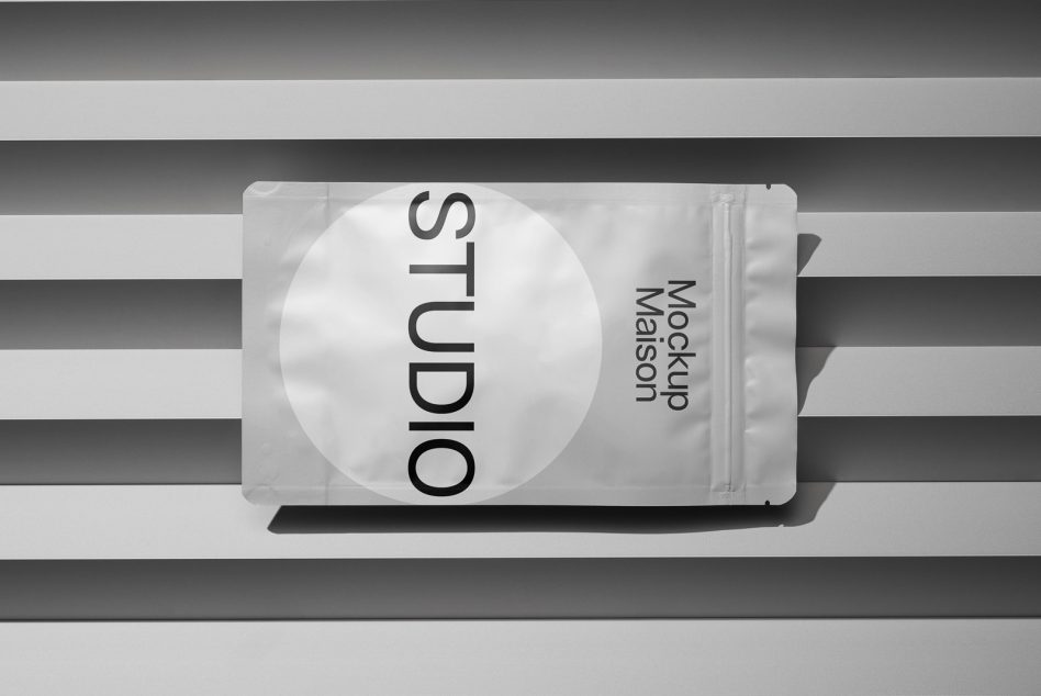 Light gray foil pouch mockup with circular cutout on striped backdrop