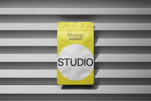 Bright yellow packaging mockup with modern design against a striped shadow background, ideal for presentations and branding.