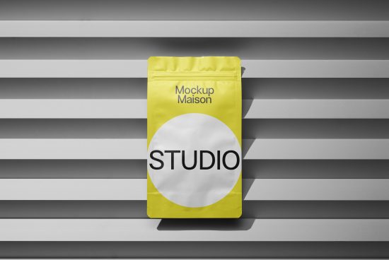Bright yellow packaging mockup with modern design against a striped shadow background, ideal for presentations and branding.