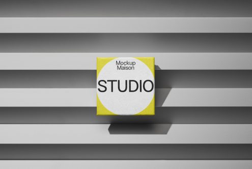 Square poster mockup with yellow and white design on a striped gray backdrop perfect for branding, presentation, and portfolio designs.