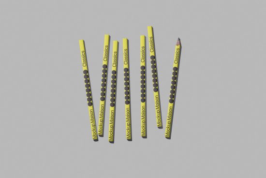 Yellow pencils with branded graphics floating on a gray background, ideal for stationery mockups, design assets, realistic templates.