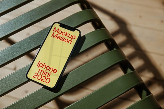 High-quality iPhone mini 2020 mockup on green chair with shadow, ideal for showcasing app and website designs for designers.