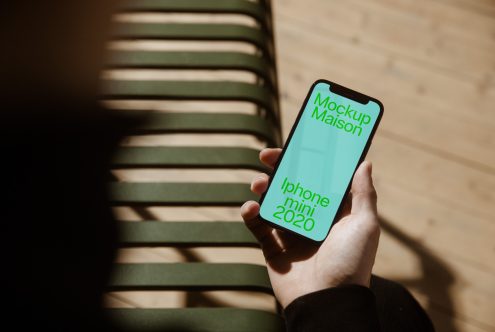 Hand holding smartphone with screen mockup against a blurred background, ideal for presenting app design or mobile interface.