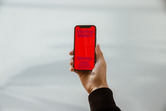 Hand holding iPhone with red screen mockup against white background, ideal for app design and UX/UI presentations, digital asset for designers.
