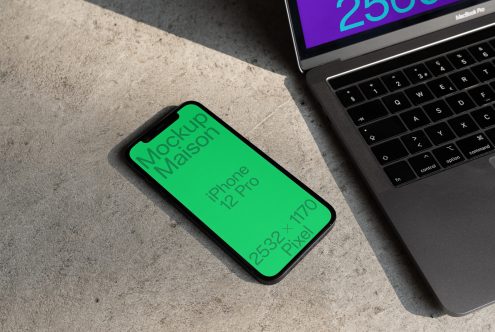 Smartphone mockup on concrete next to laptop showcasing screen dimensions for design presentation, digital asset for creative professionals.