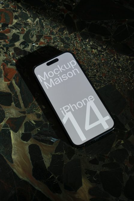 iPhone 14 mockup on a multicolor terrazzo surface, perfect for design presentations and digital asset portfolios.