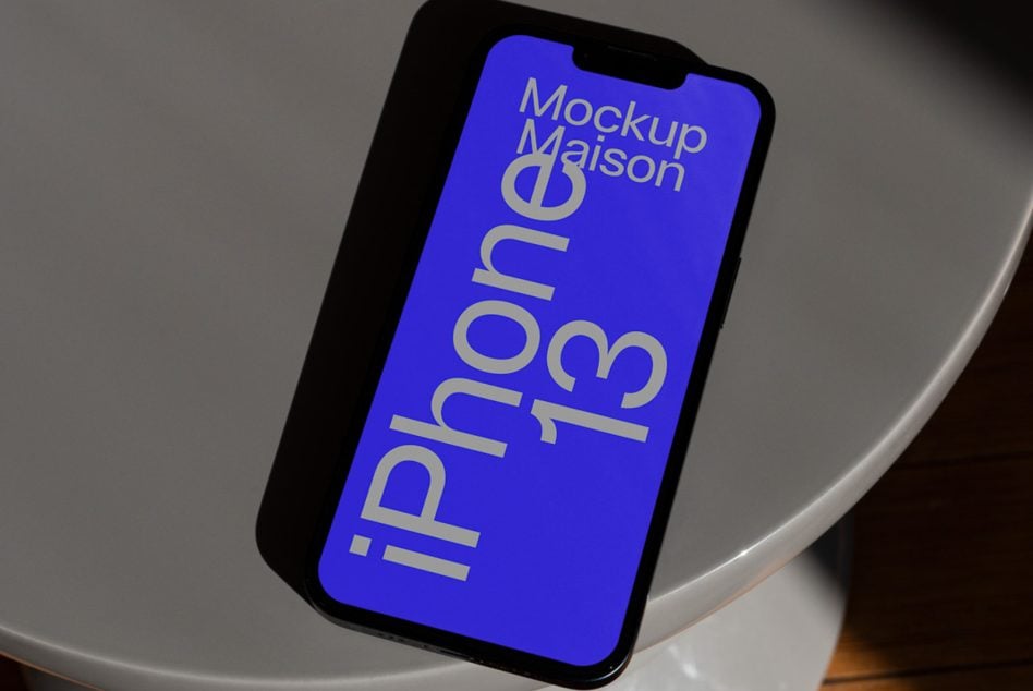 iPhone 13 mockup on white bowl with blue screen in bright lighting