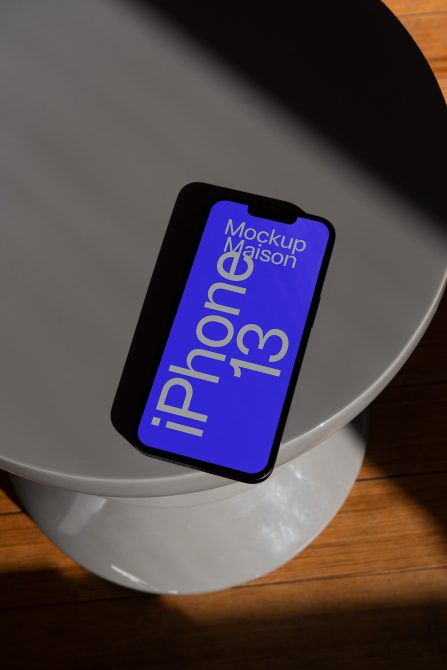 iPhone 13 mockup on white bowl with blue screen display