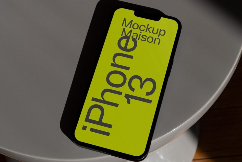 iPhone 13 mockup on white bowl with neon yellow screen display