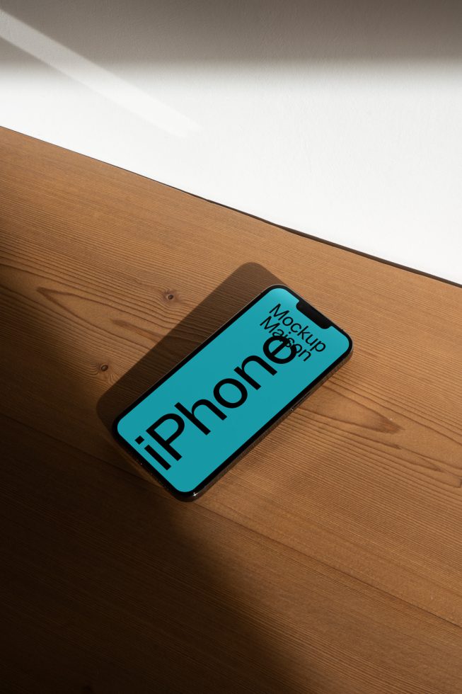 Smartphone mockup on wooden surface with dynamic shadows, ideal for presenting app designs and mobile user interfaces to designers.