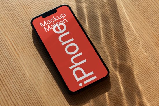 Smartphone screen mockup template on wooden surface for UI/UX design presentation, showcasing responsive design in a realistic setting.