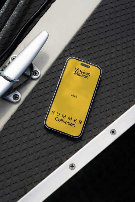 Yellow iPhone on dark textured surface with white water bottle in frame