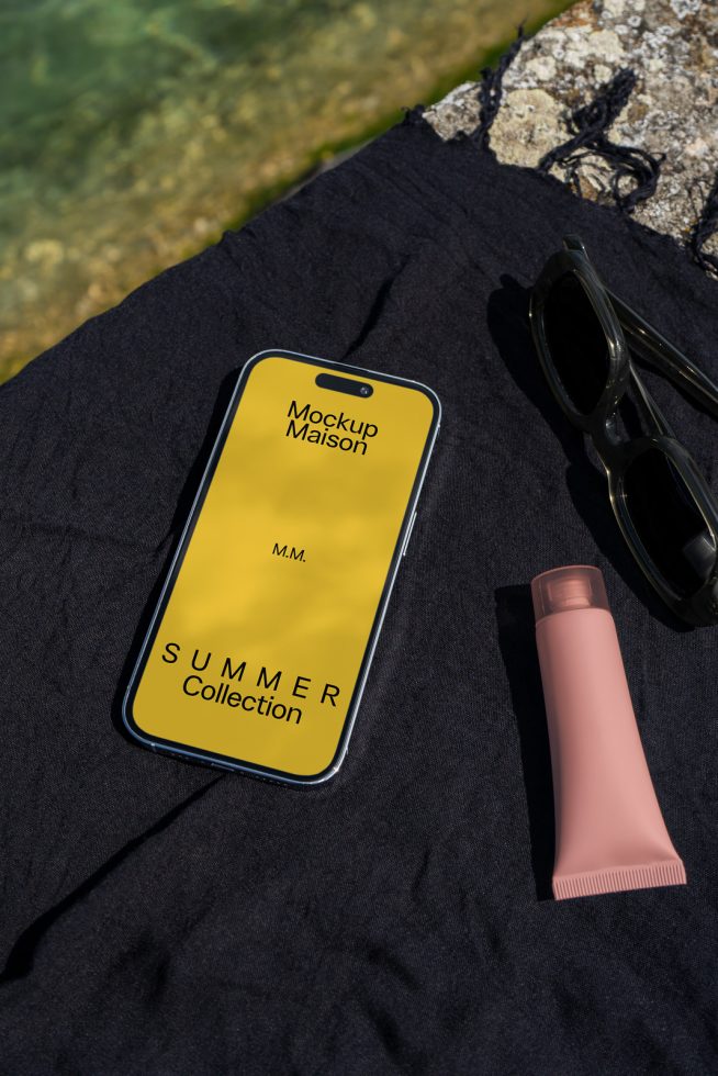 Smartphone mockup on fabric with sunglasses and lotion, showcasing a summer collection ad, perfect for designers looking for realistic mockups.