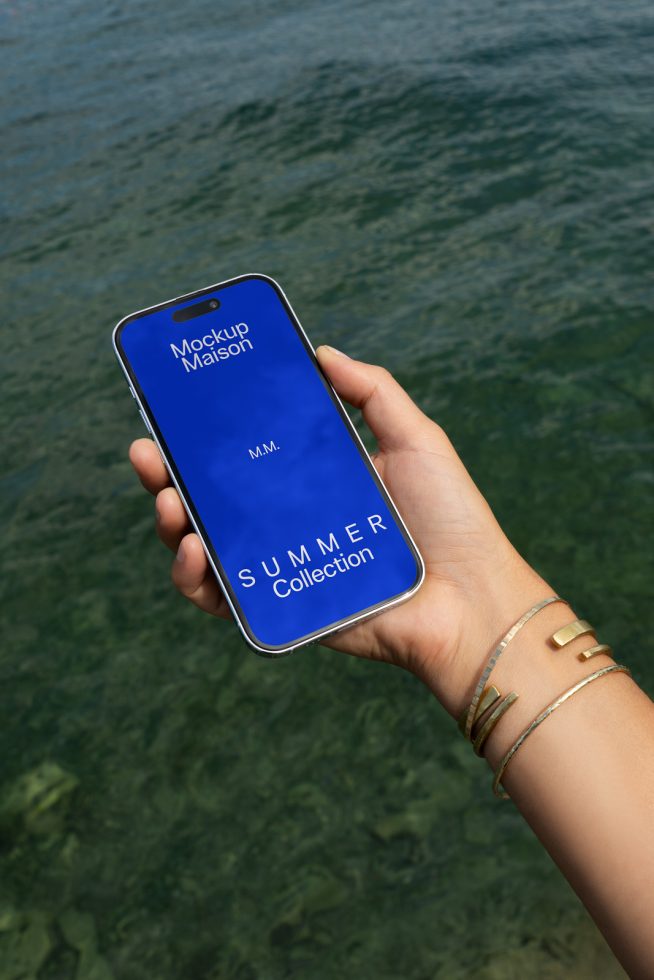 Smartphone screen mockup held over water background, displaying 'Summer Collection' design, ideal for digital asset presentations.