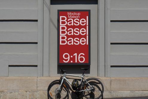 Outdoor billboard mockup in urban setting with parked bicycle, showcasing bold red design with white typography ideal for designers and advertisers.