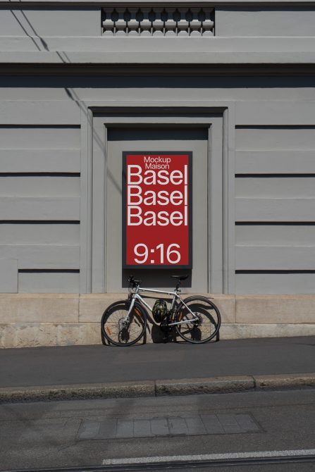 Urban poster mockup on building wall with text Basel, featuring bicycle in lower frame, suitable for advertising design presentations.