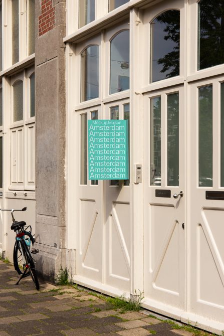 Urban poster mockup on classic European building with bicycle, designers can use for showcasing advertising designs, suitable for city-based marketing graphics.