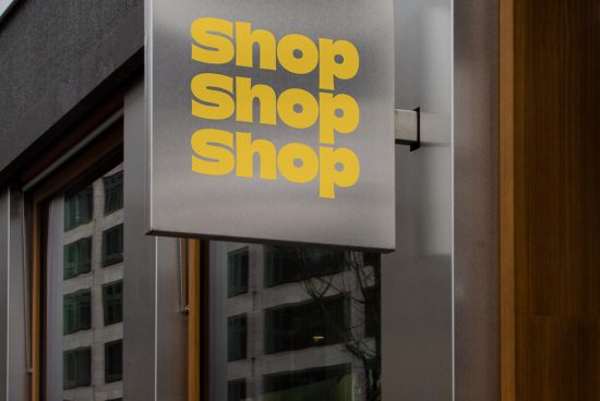 Modern shop sign mockup with bold yellow font against urban background, great for presentation and branding design.