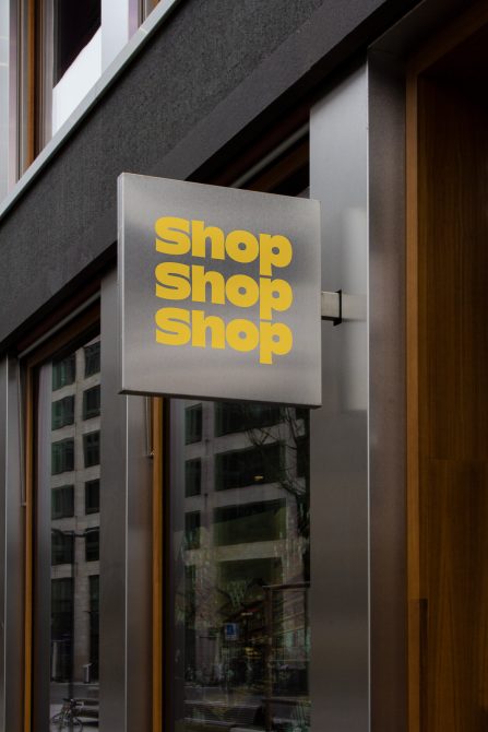 Outdoor sign mockup for storefront with modern font design displayed on a building, ideal for branding presentation.