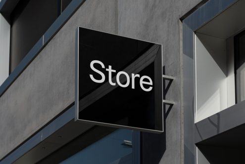 Store signboard mockup on modern building facade, showcasing urban signage design with clean, minimalist aesthetics, suitable for branding presentations.