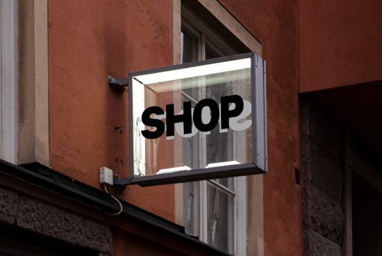Clear shop sign mockup on building facade for storefront designs, ideal for font and graphics display in urban settings.
