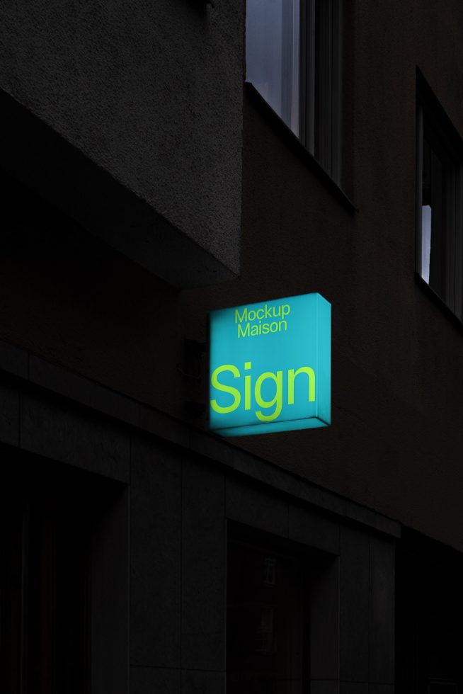 Illuminated store sign mockup on a dark building wall, showcasing a design template for branding and identity projects.